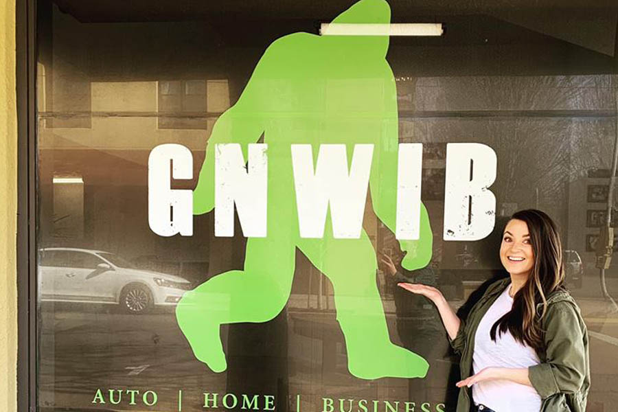 GNWIB - Employee Outside Poitning to the Sign